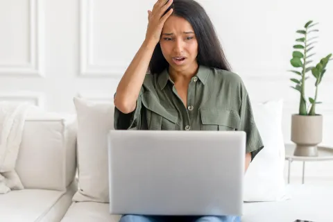 Eine Frau hat einen Cyberangriff auf ihrem Endgerät im Homeoffice entdeckt. Tipps für mehr Cybersicherheit im Homeoffice erhältst du hier. © Adobe Stock, Vadim Pastuh